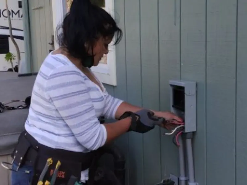 Licensed electrician wiring an exterior subpanel in Devils Lake